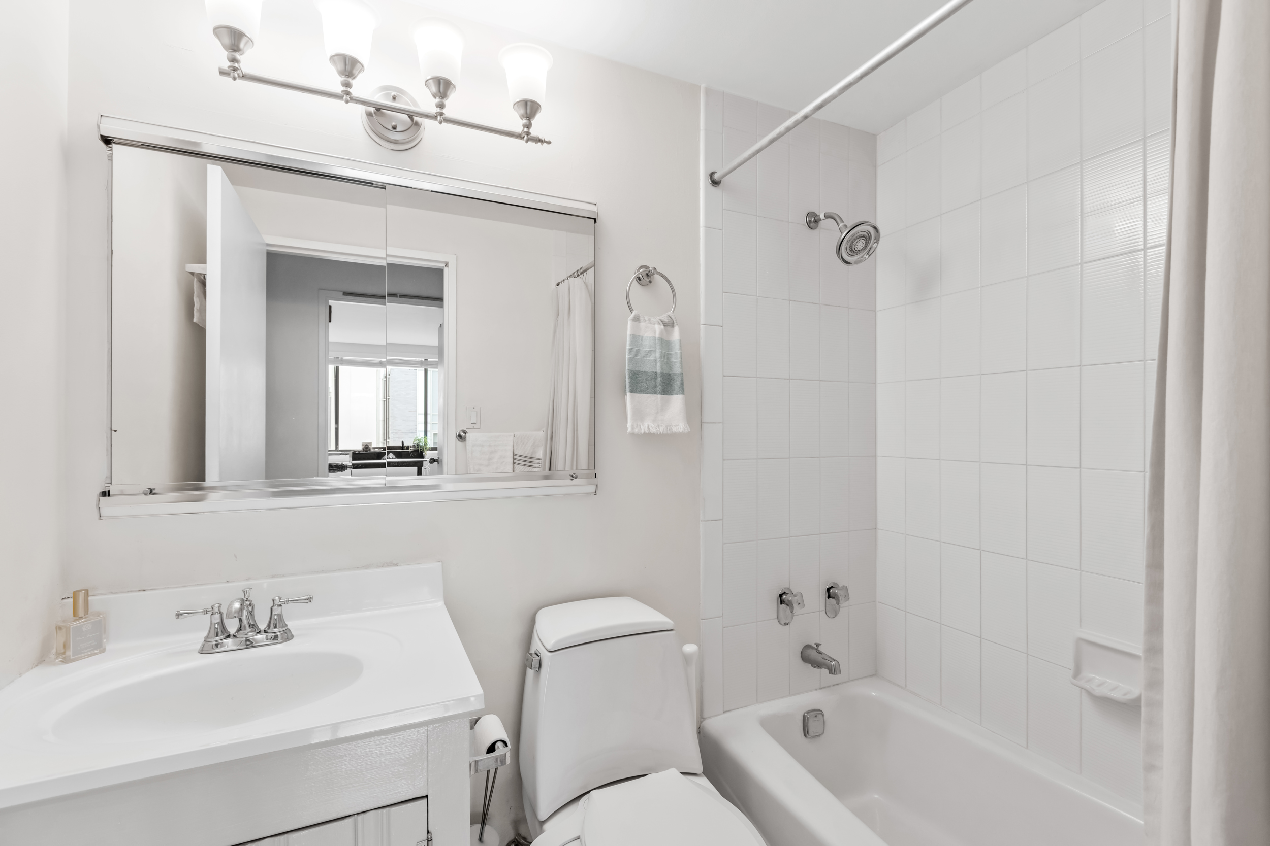 63 Downing Street, Unit 8C Manhattan, NY 10014 - Photo 13 of 15 a bathroom with a sink toilet and shower