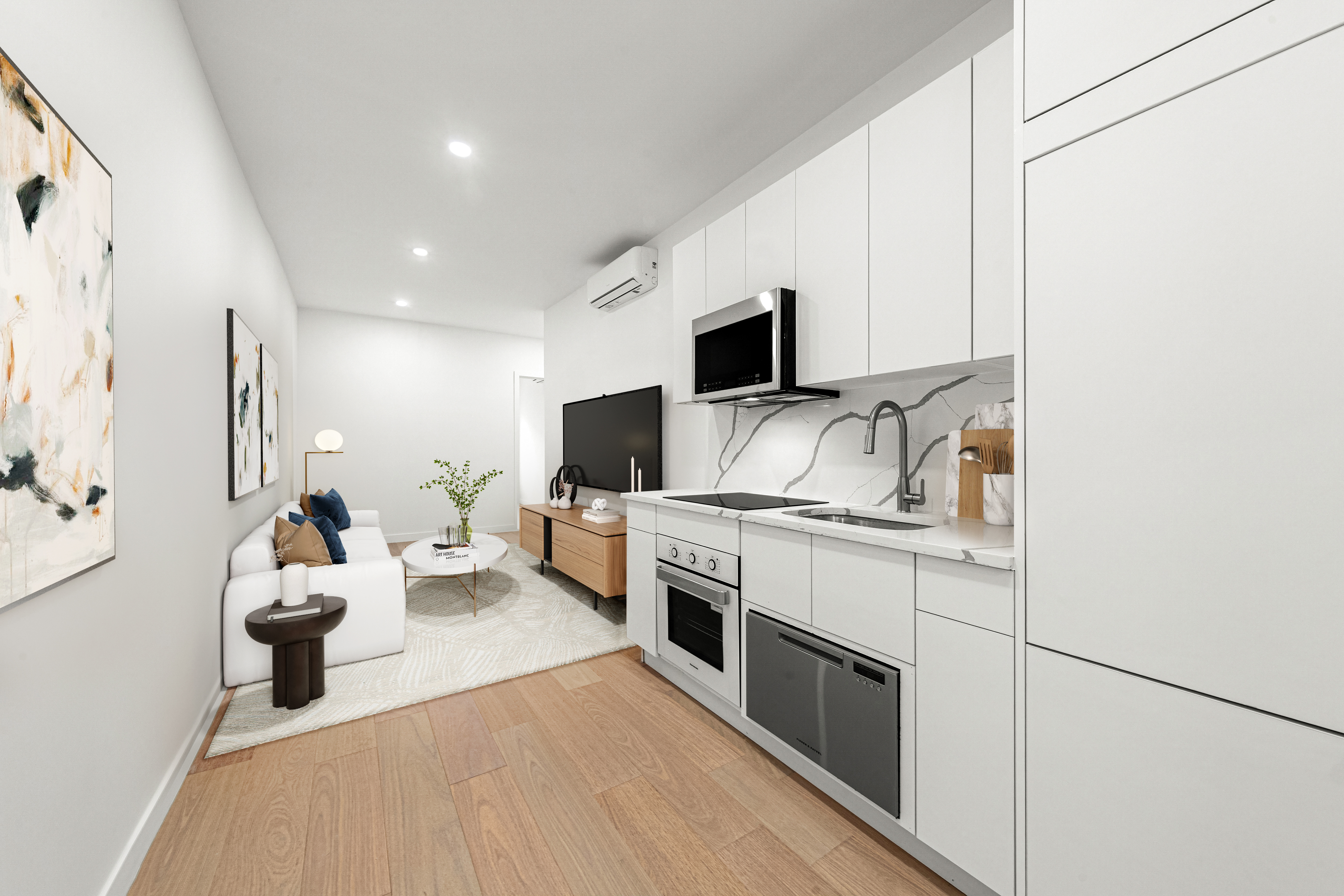 177 East 3rd Street, Unit 2A Manhattan, NY 10009 - Photo 3 of 8 a large living room with stainless steel appliances furniture a flat screen tv and a couch