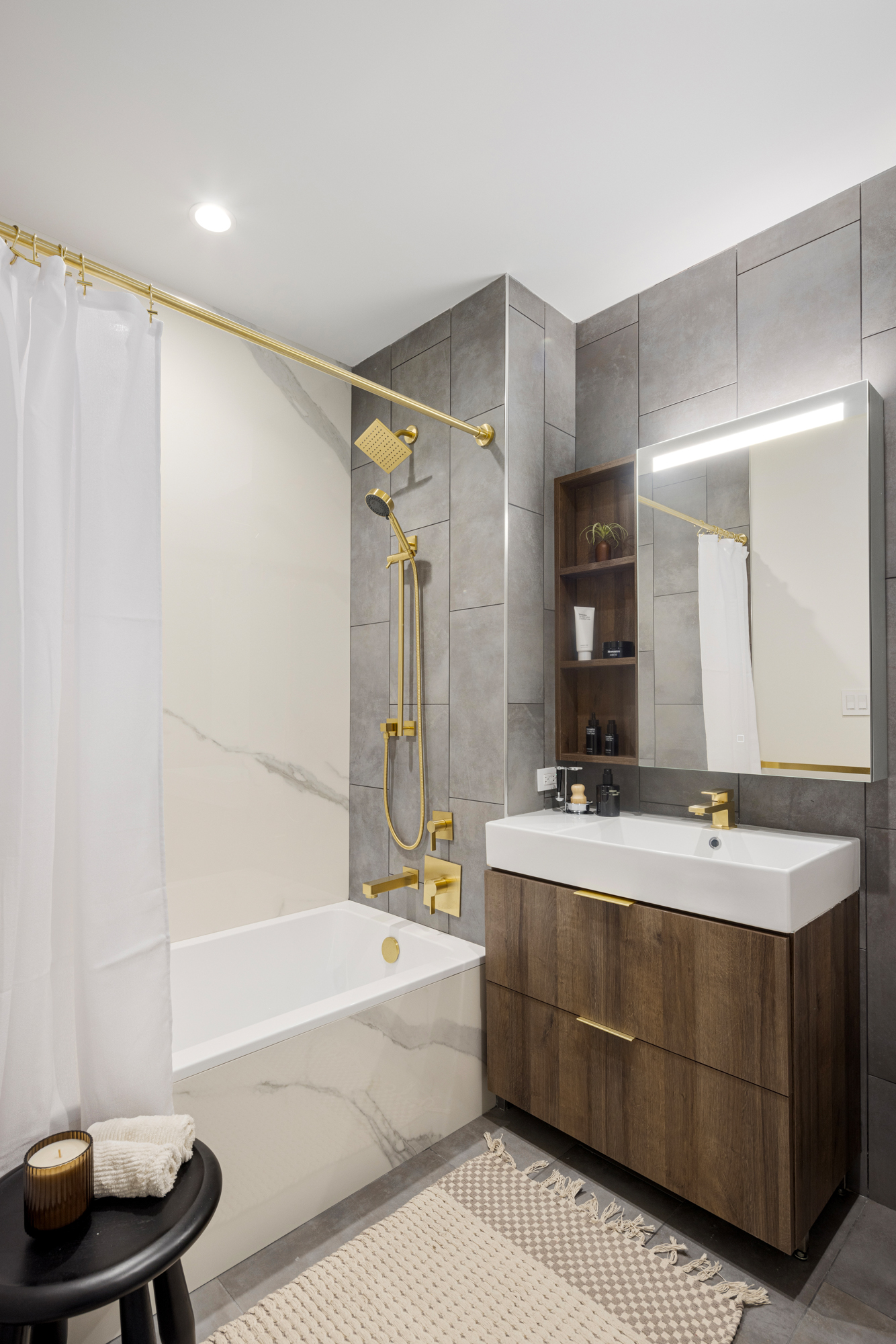 980 6th Avenue, Unit 423 Manhattan, NY 10018 - Photo 3 of 19 a bathroom with a tub sink and mirror