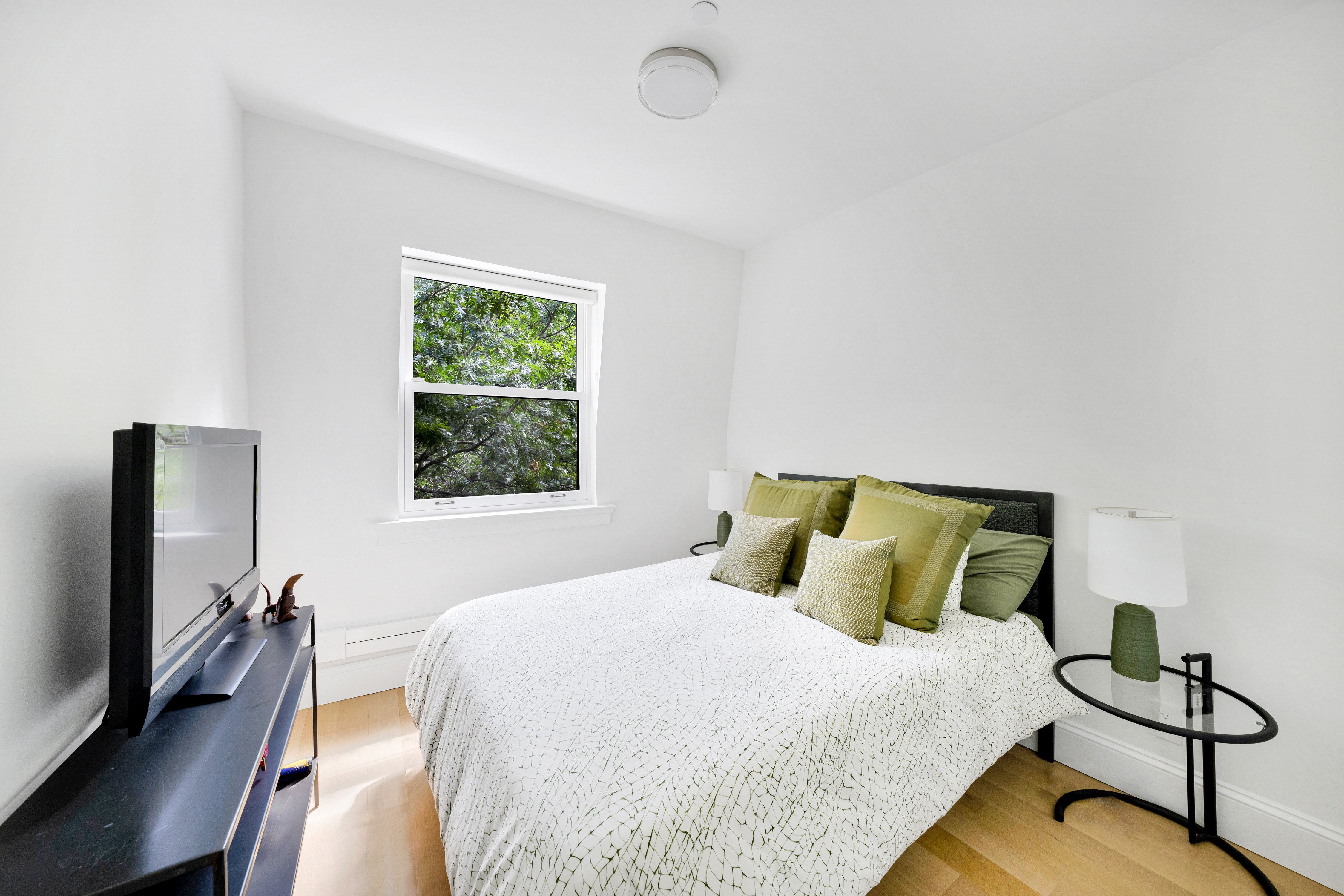 215 Lafayette Avenue, Unit C Brooklyn, NY 11238 - Photo 10 of 17 a bedroom with a bed tv and window