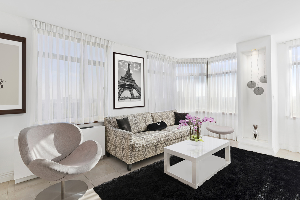 112-01 Queens Boulevard, Unit 8B Queens, NY 11375 - Photo 3 of 16 a living room with furniture and a window