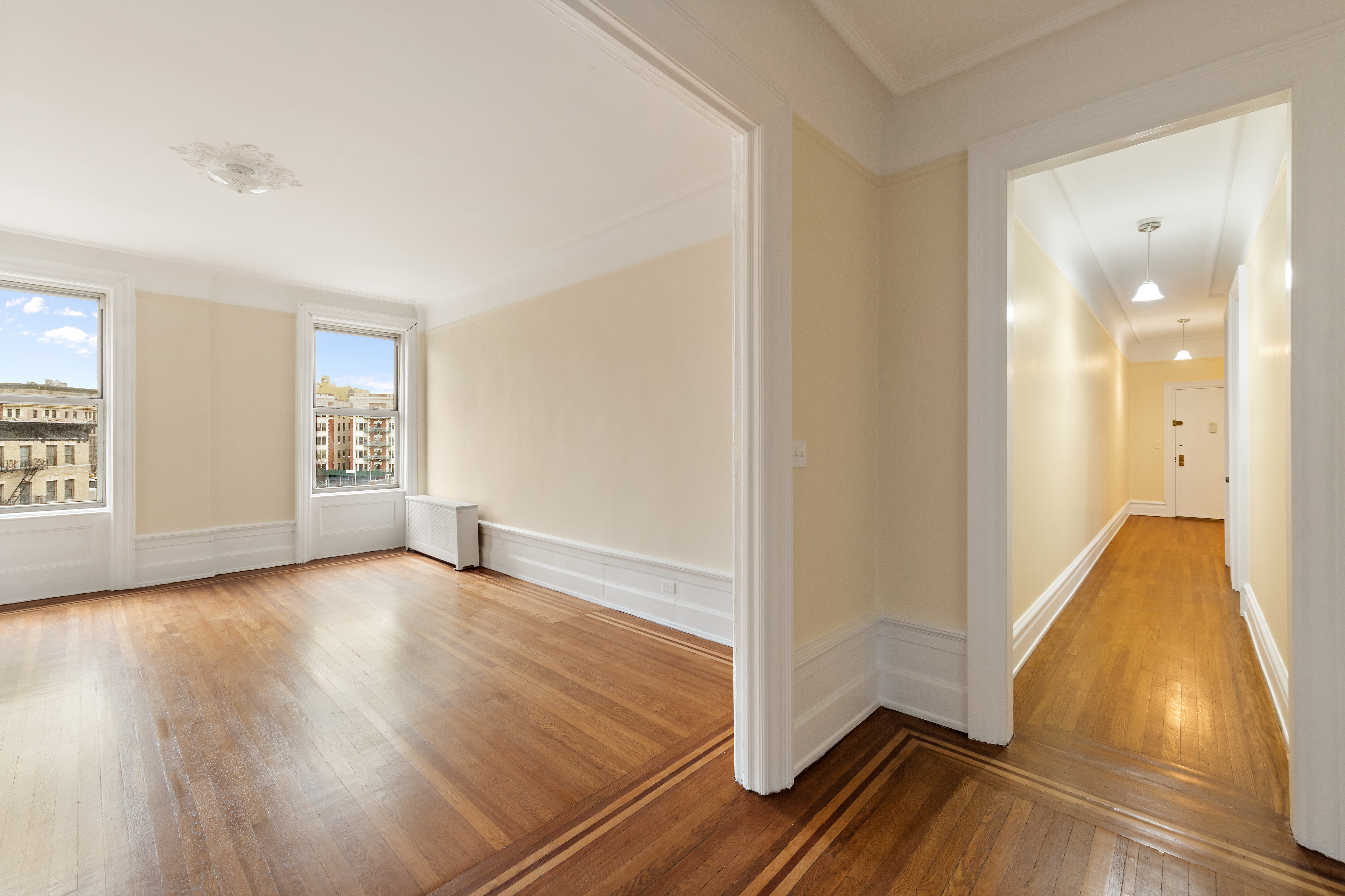 800 Riverside Drive, Unit 6E Manhattan, NY 10032 - Photo 4 of 30 an empty room with wooden floor and windows