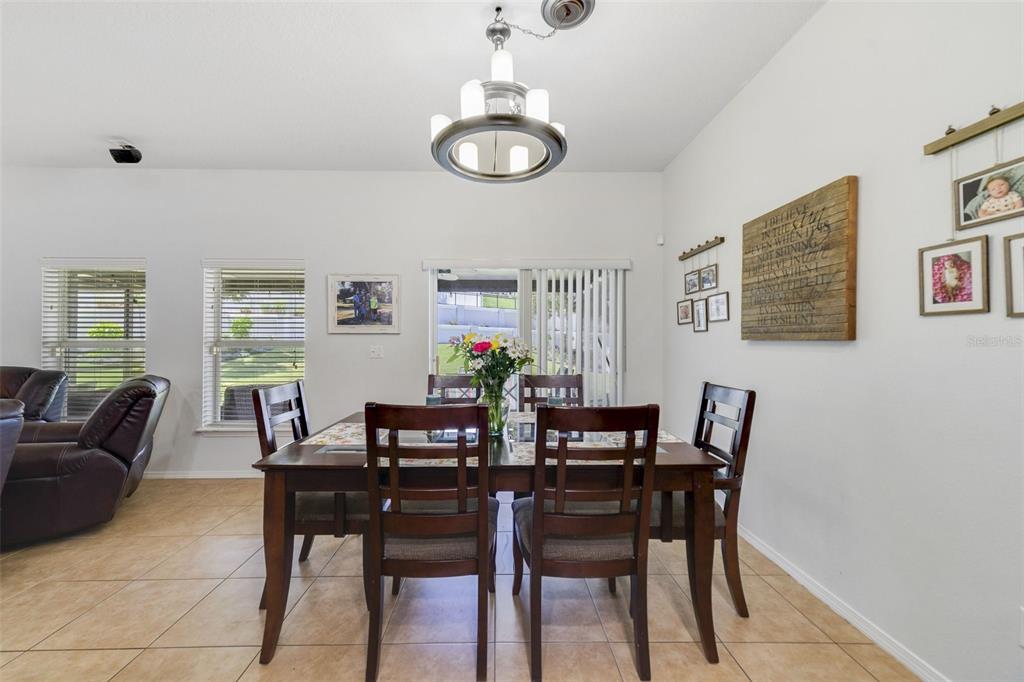 352 Giovani Boulevard Clermont, FL 34715 - Photo 12 of 46 a view of a dining room with furniture and chandelier