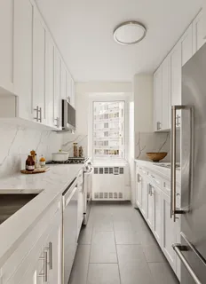 a kitchen with stainless steel appliances a white cabinets and a sink