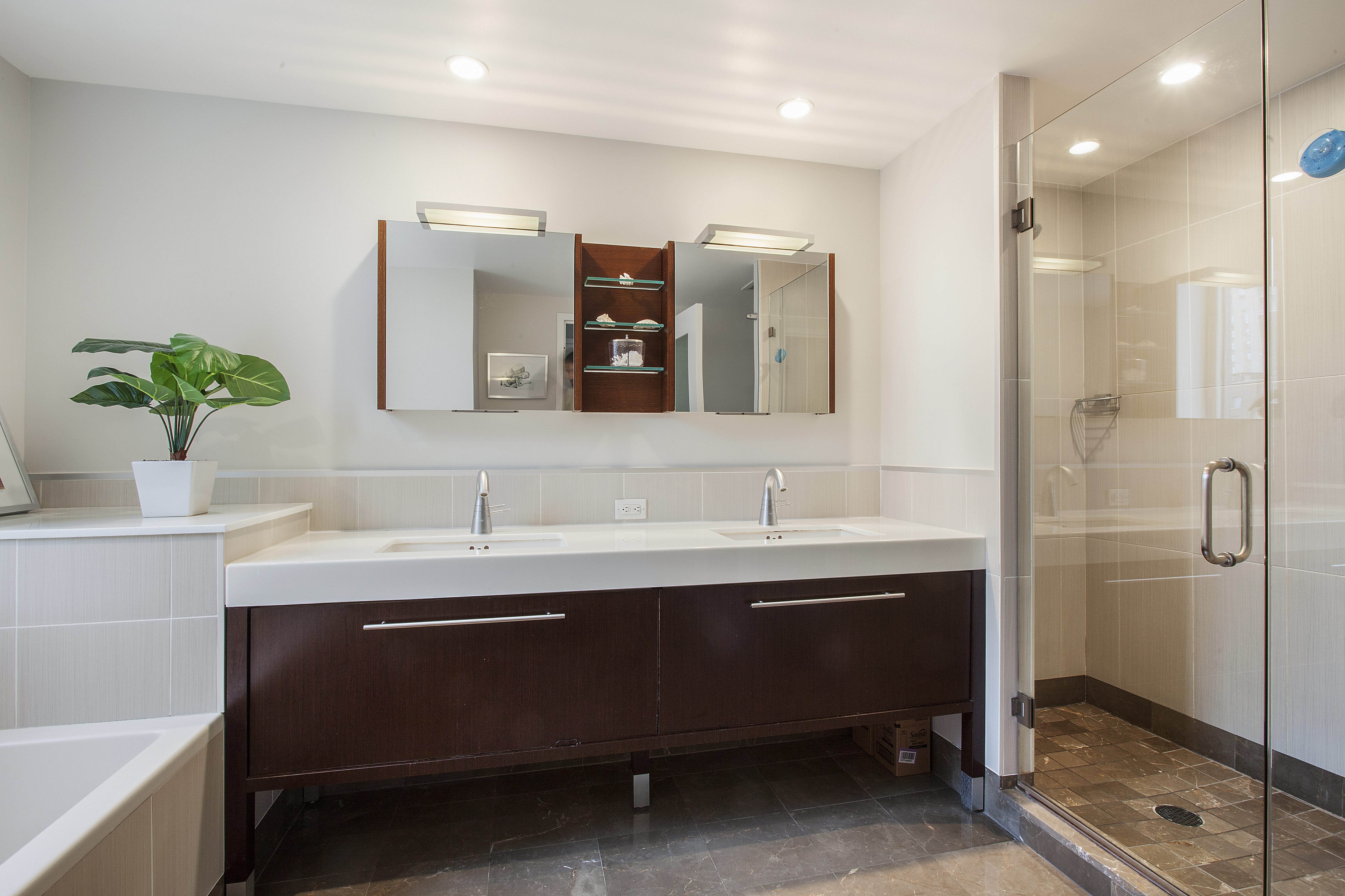 225 East 34th Street, Unit 17C Manhattan, NY 10016 - Photo 6 of 19 a bathroom with a sink and a mirror