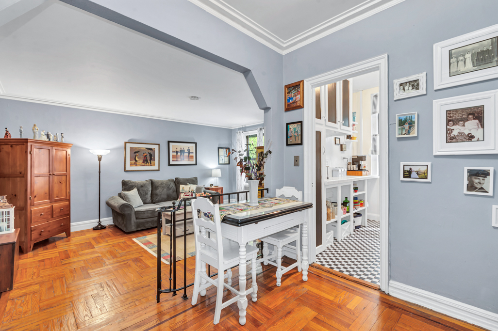 350 Cabrini Boulevard, Unit 6N Manhattan, NY 10040 - Photo 3 of 9 a living room with furniture a rug and a painting on the wall
