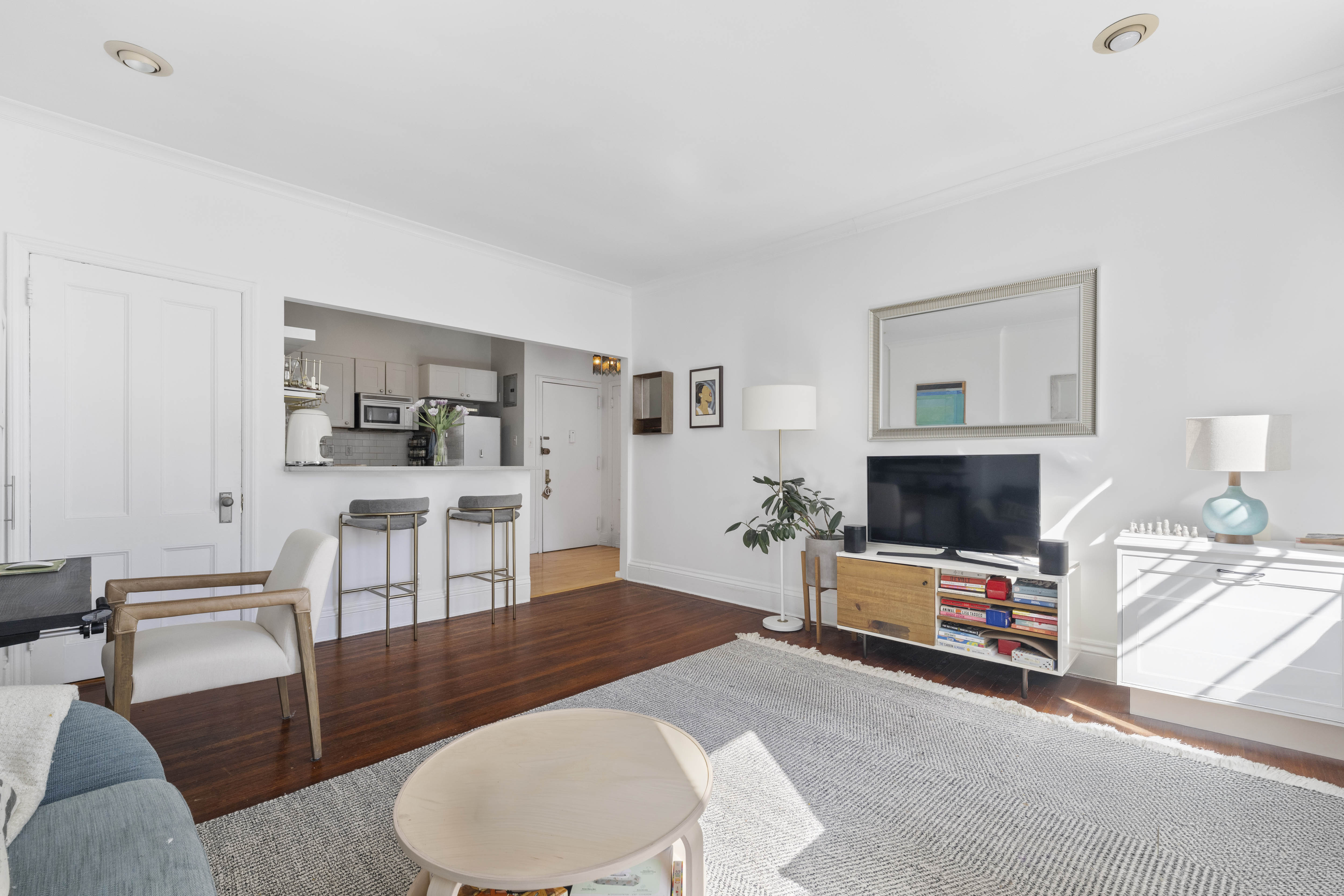 21 Monroe Place, Unit 5F Brooklyn, NY 11201 - Photo 2 of 10 a living room with furniture and a flat screen tv