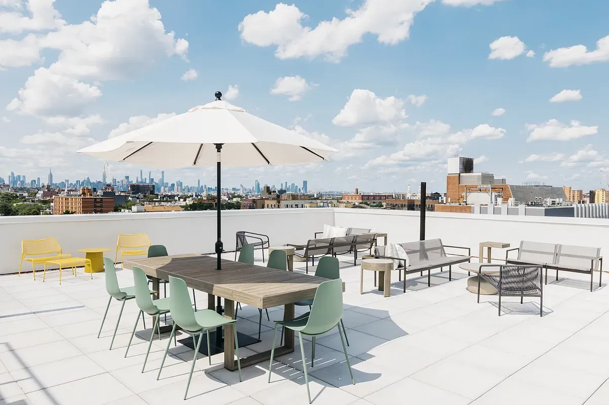 a terrace with outdoor seating city view and ocean view