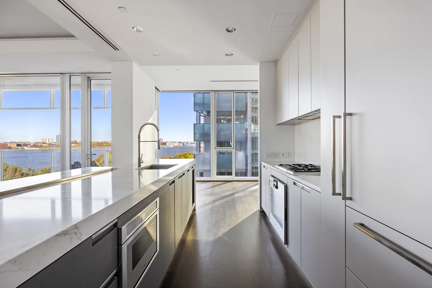 a large kitchen with stainless steel appliances granite countertop a lot of counter space and a large window