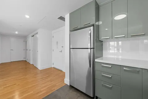 a kitchen with a refrigerator and a sink