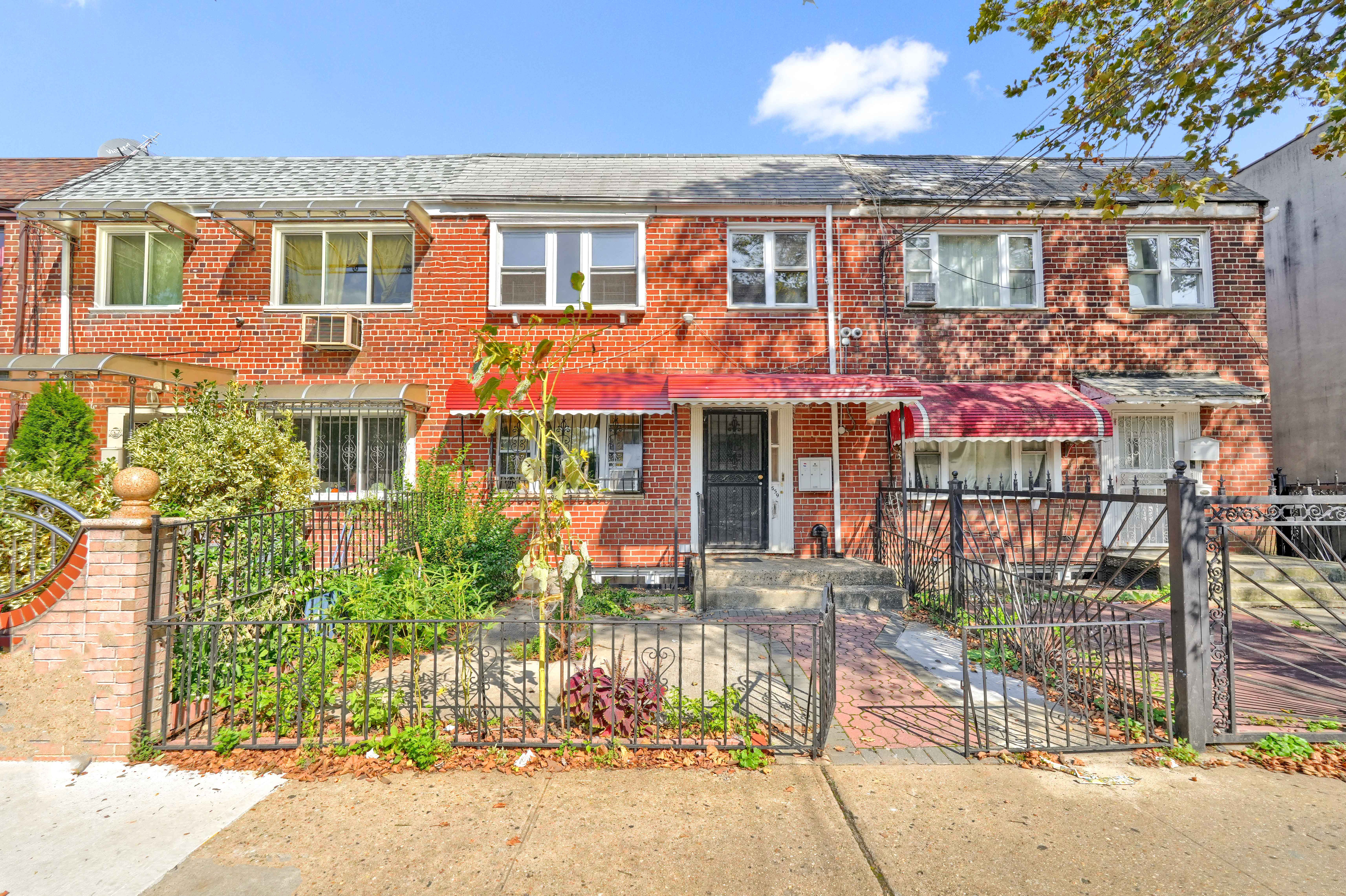 659 Jerome Street Brooklyn, NY 11207 - Photo 2 of 39 front view of a brick house with a blue windows