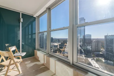 a view of a dining room with furniture and a window