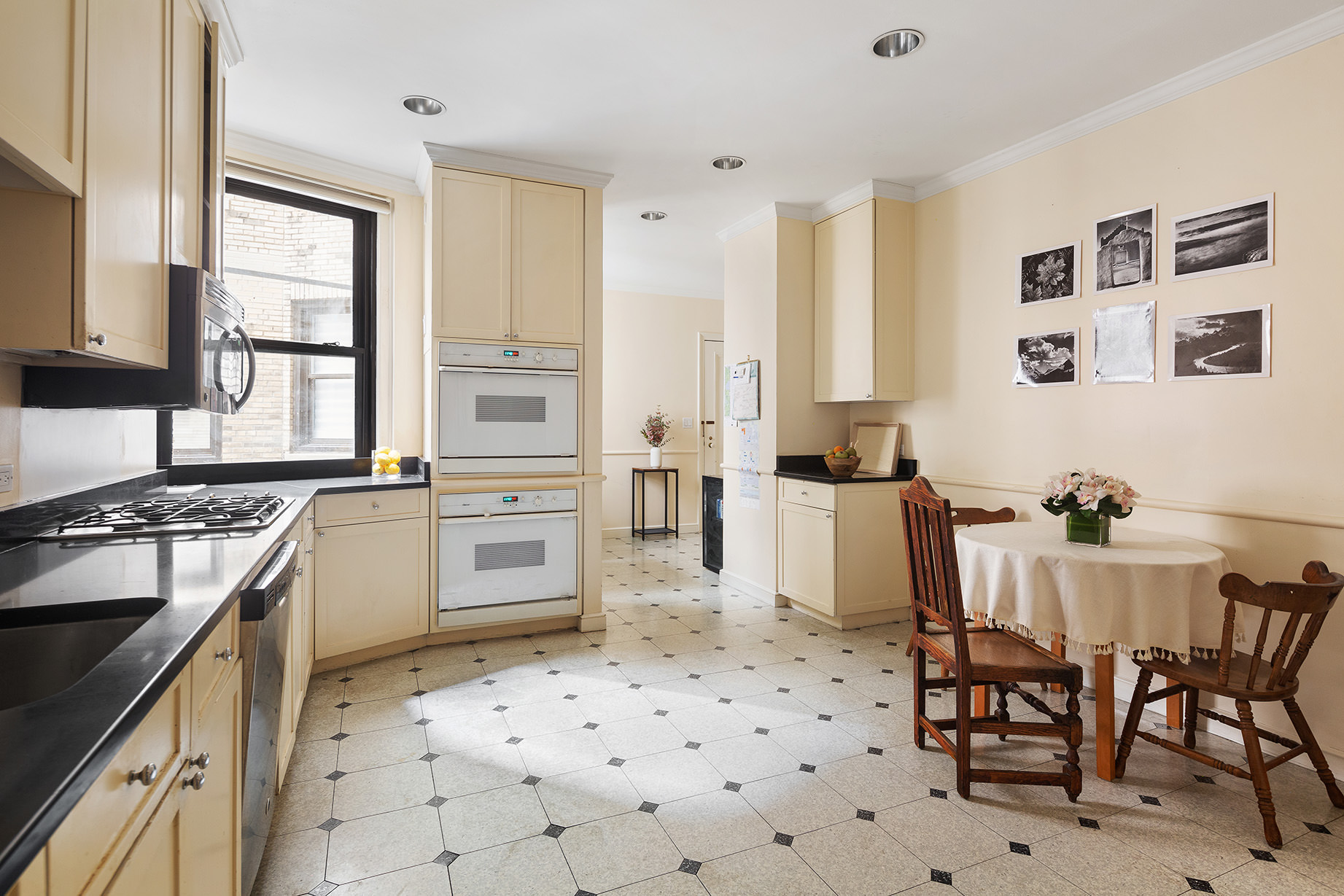 1115 5th Avenue, Unit 5B Manhattan, NY 10128 - Photo 12 of 19 a kitchen with granite countertop a stove a sink and a refrigerator