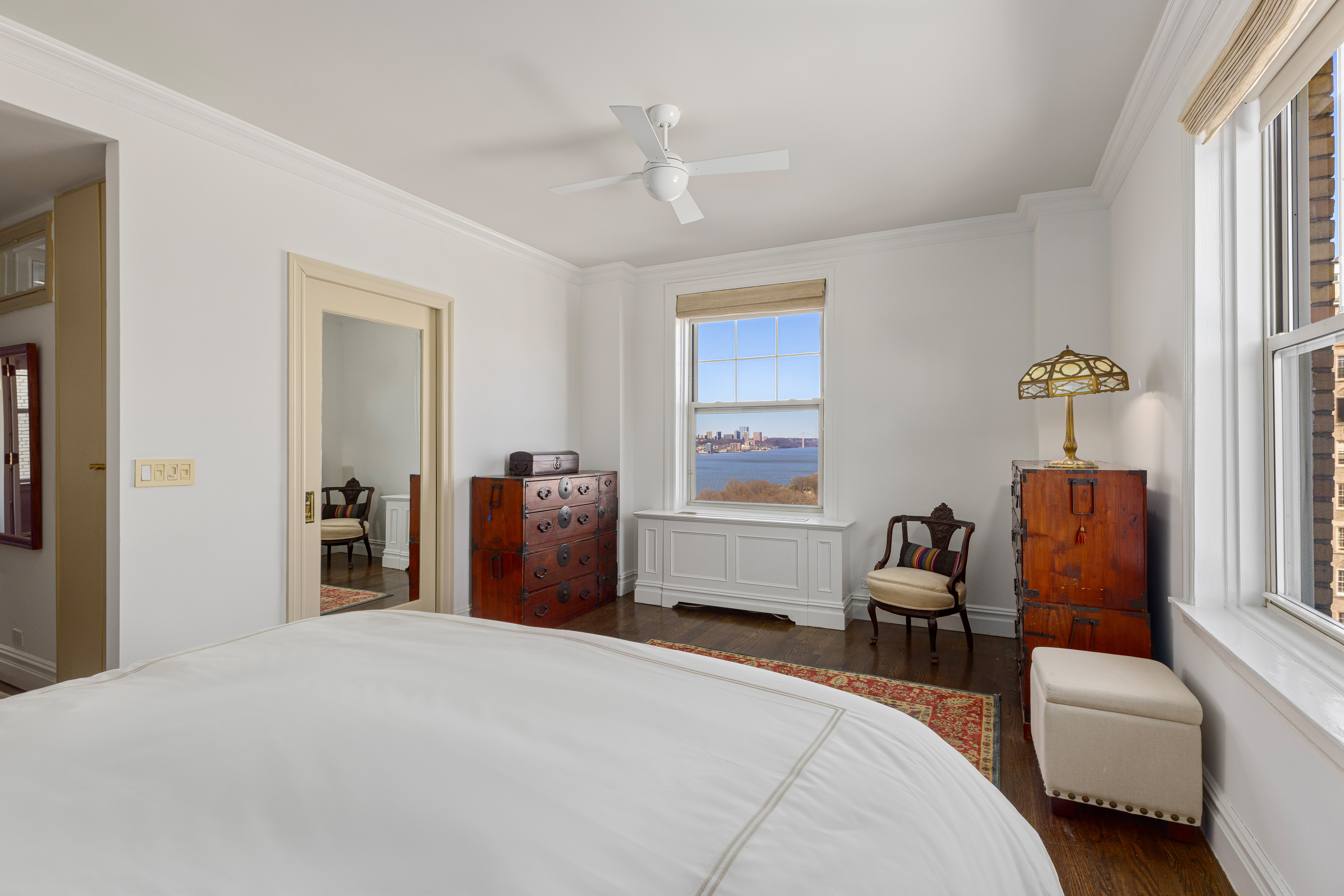 160 Riverside Drive, Unit 12D Manhattan, NY 10024 - Photo 7 of 14 a bedroom with bed and a window