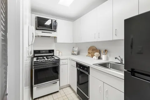 a kitchen with stainless steel appliances granite countertop a sink stove oven and refrigerator