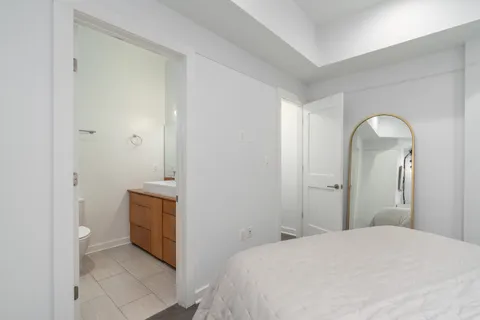 a en suite bathroom with a granite countertop sink and a mirror
