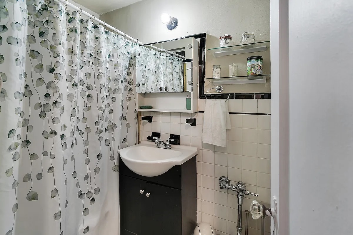 240 East 24th Street, Unit 4G Manhattan, NY 10010 - Photo 4 of 9 a bathroom with a sink and mirror