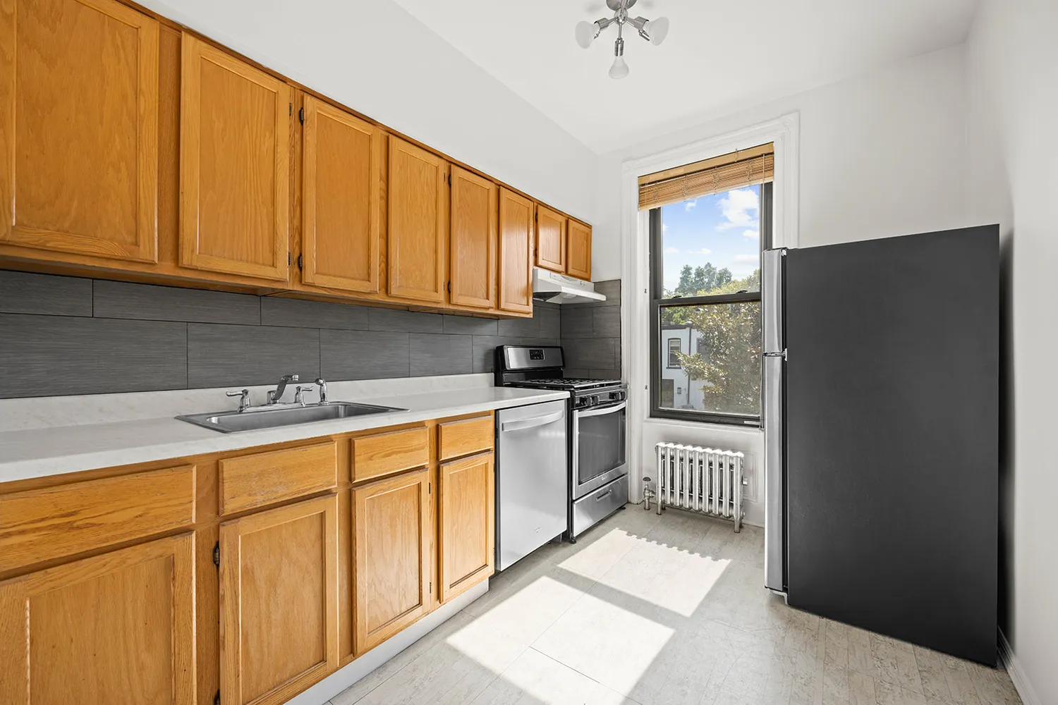 a kitchen with stainless steel appliances granite countertop a refrigerator sink and cabinets