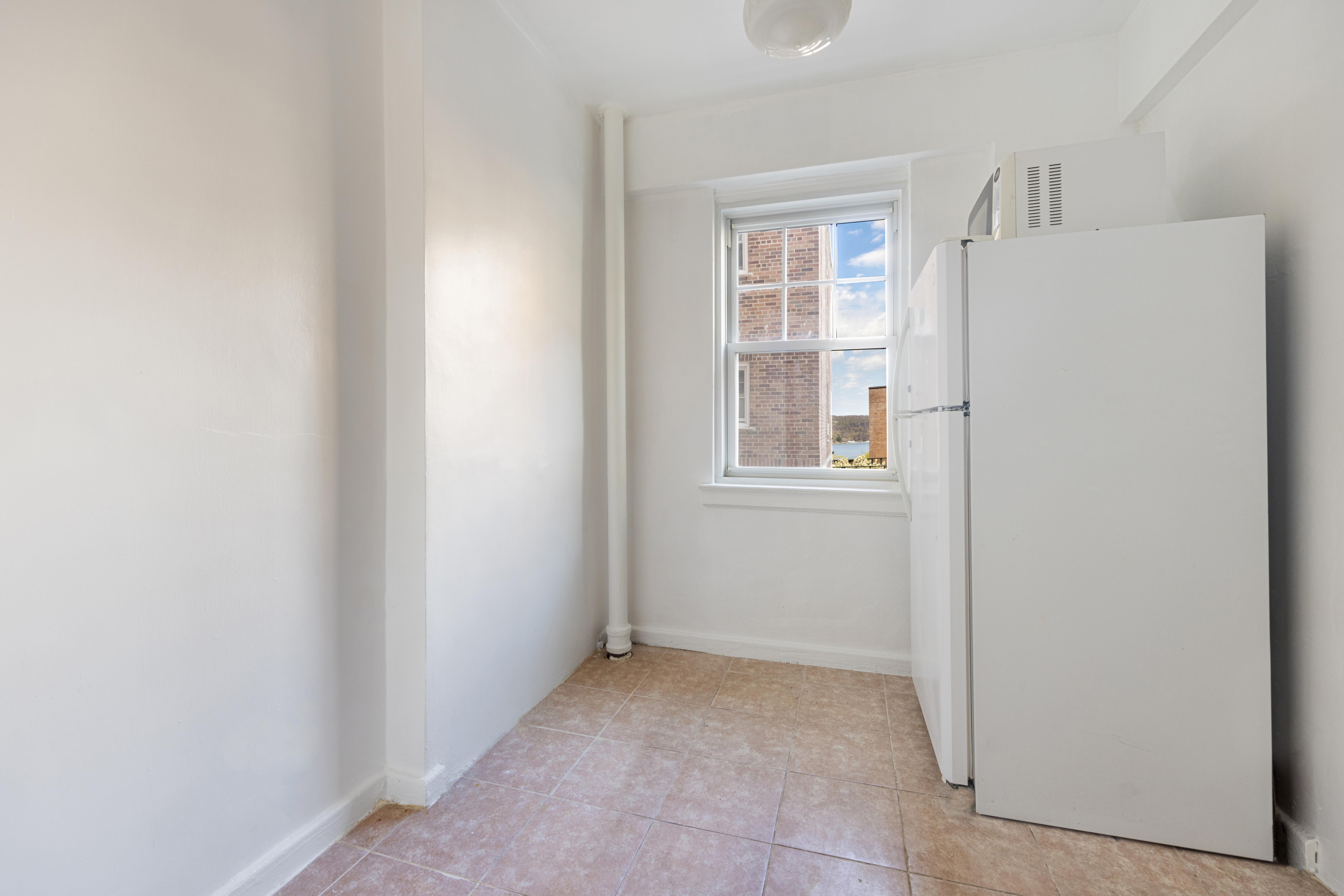 200 Cabrini Boulevard, Unit 17 Manhattan, NY 10033 - Photo 7 of 24 a view of an empty room with a window