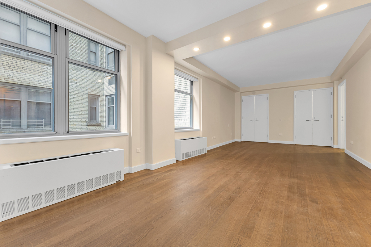 100 West 58th Street, Unit 12A Manhattan, NY 10019 - Photo 5 of 15 a view of empty room with a window