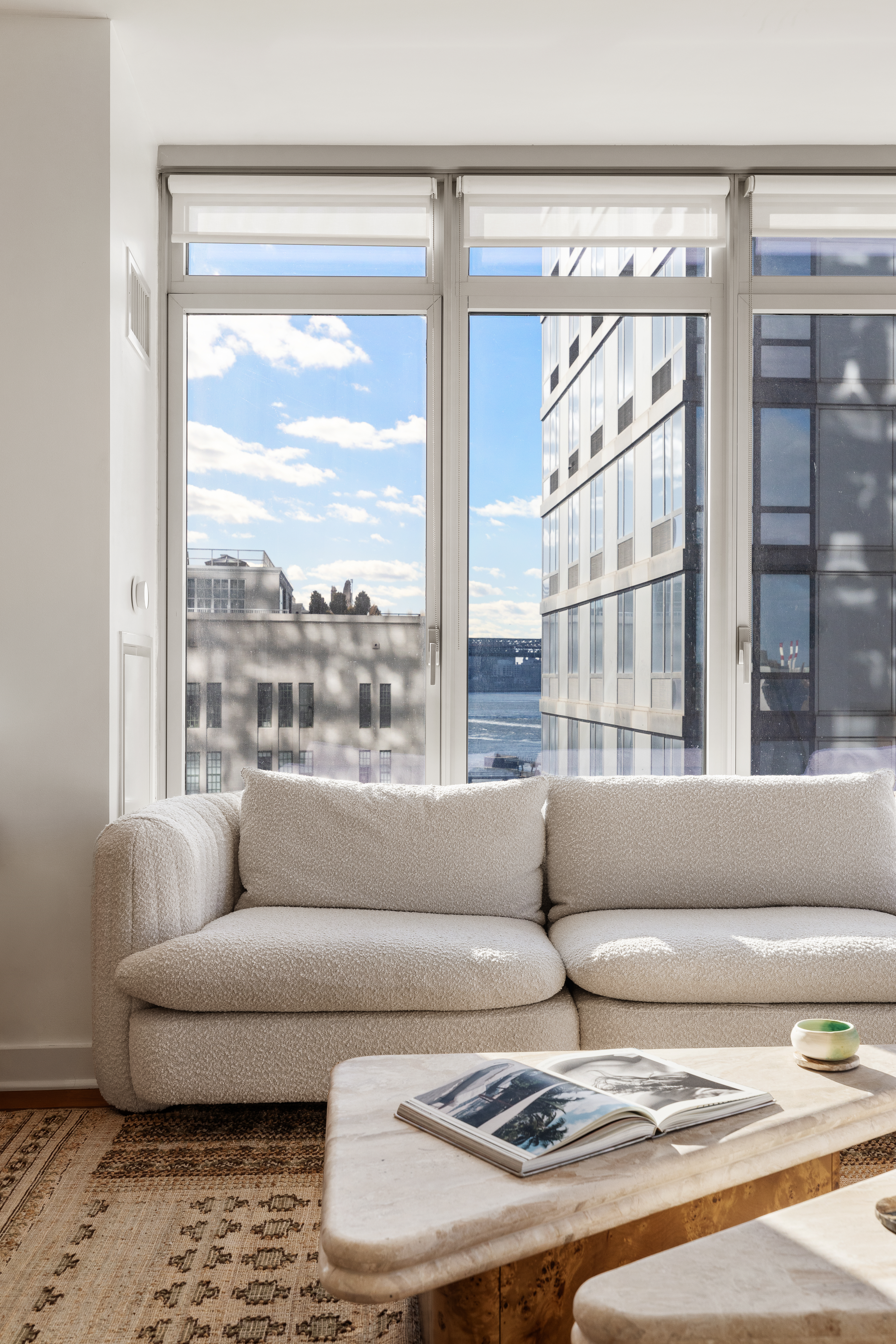 2 Northside Piers, Unit 8A Brooklyn, NY 11249 - Photo 10 of 11 a living room with furniture and a large window