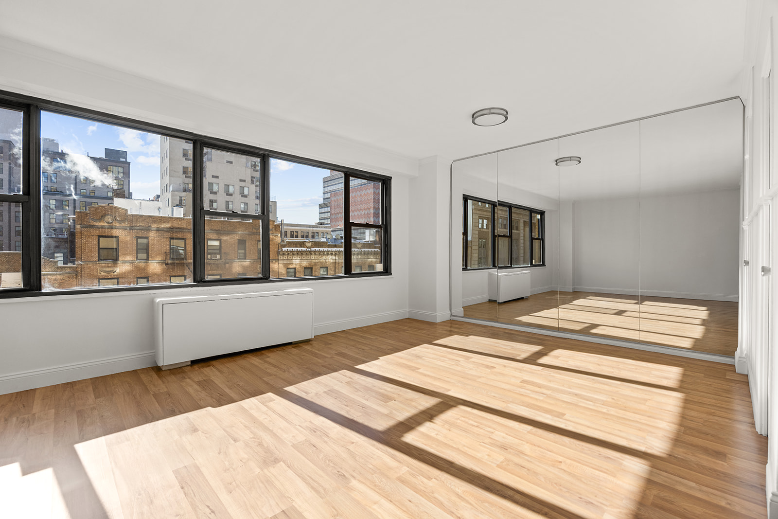 85 Livingston Street, Unit 6F Brooklyn, NY 11201 - Photo 4 of 11 a bedroom with a large bed and a large window with outer view