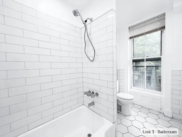 a bathroom with a toilet sink and shower