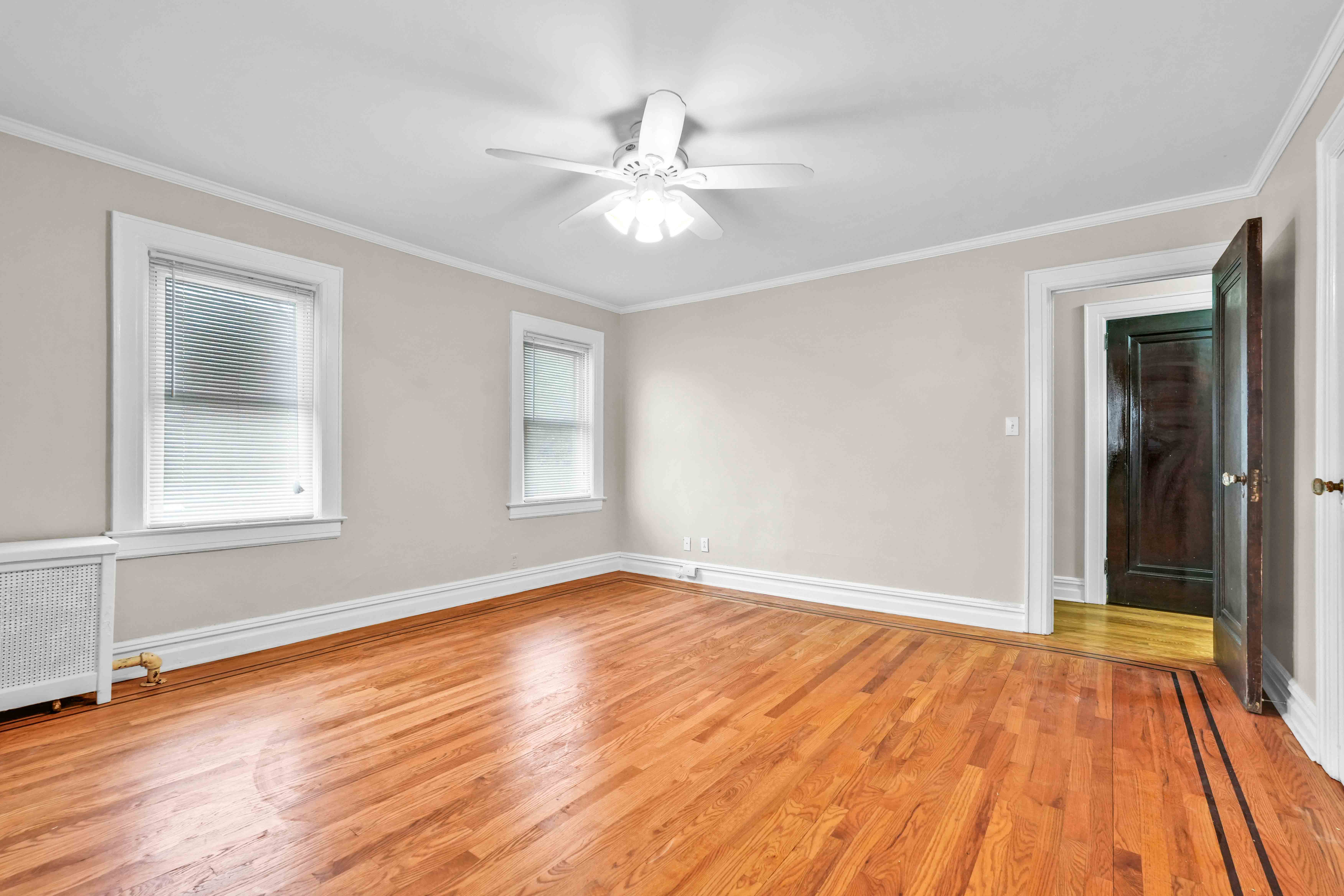 188-22 Lewiston Avenue, Unit 1 Queens, NY 11412 - Photo 11 of 17 a view of an empty room with wooden floor and a window