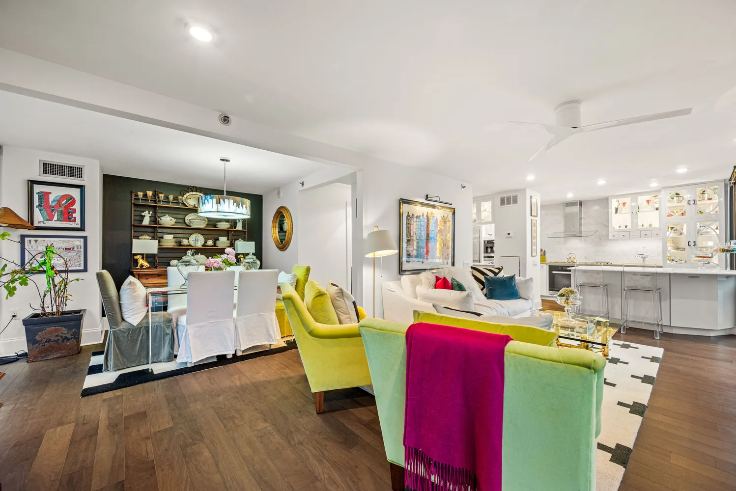 a living room with furniture and kitchen view