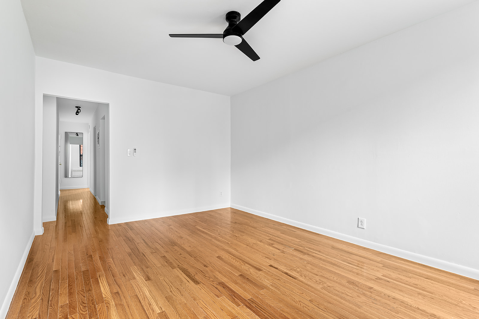 169 Allen Street, Unit 1C Manhattan, NY 10002 - Photo 3 of 12 a view of empty room with wooden floor