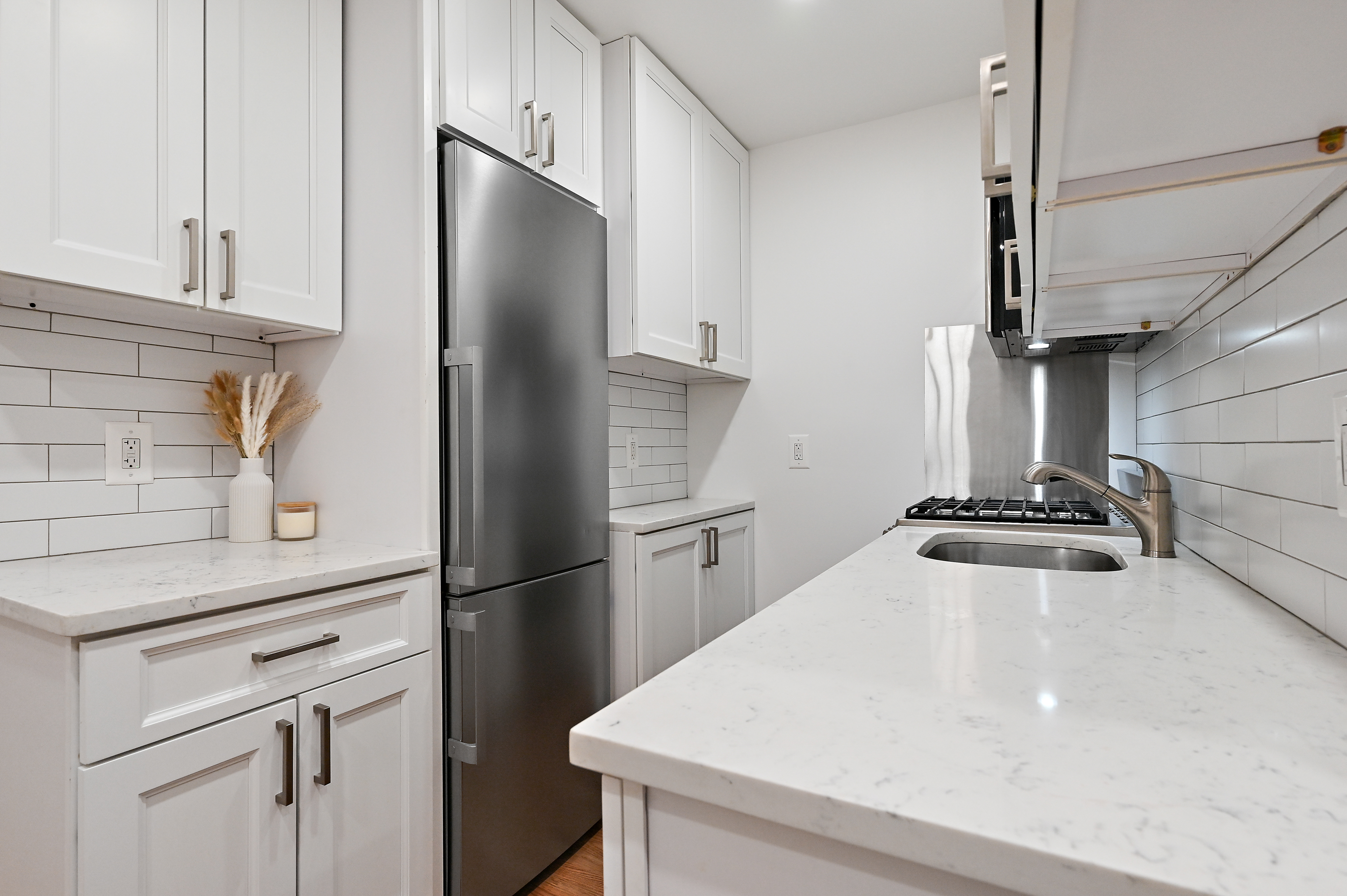 5823 Fieldston Road, Unit 1A Bronx, NY 10471 - Photo 5 of 26 a kitchen with stainless steel appliances a refrigerator and a stove