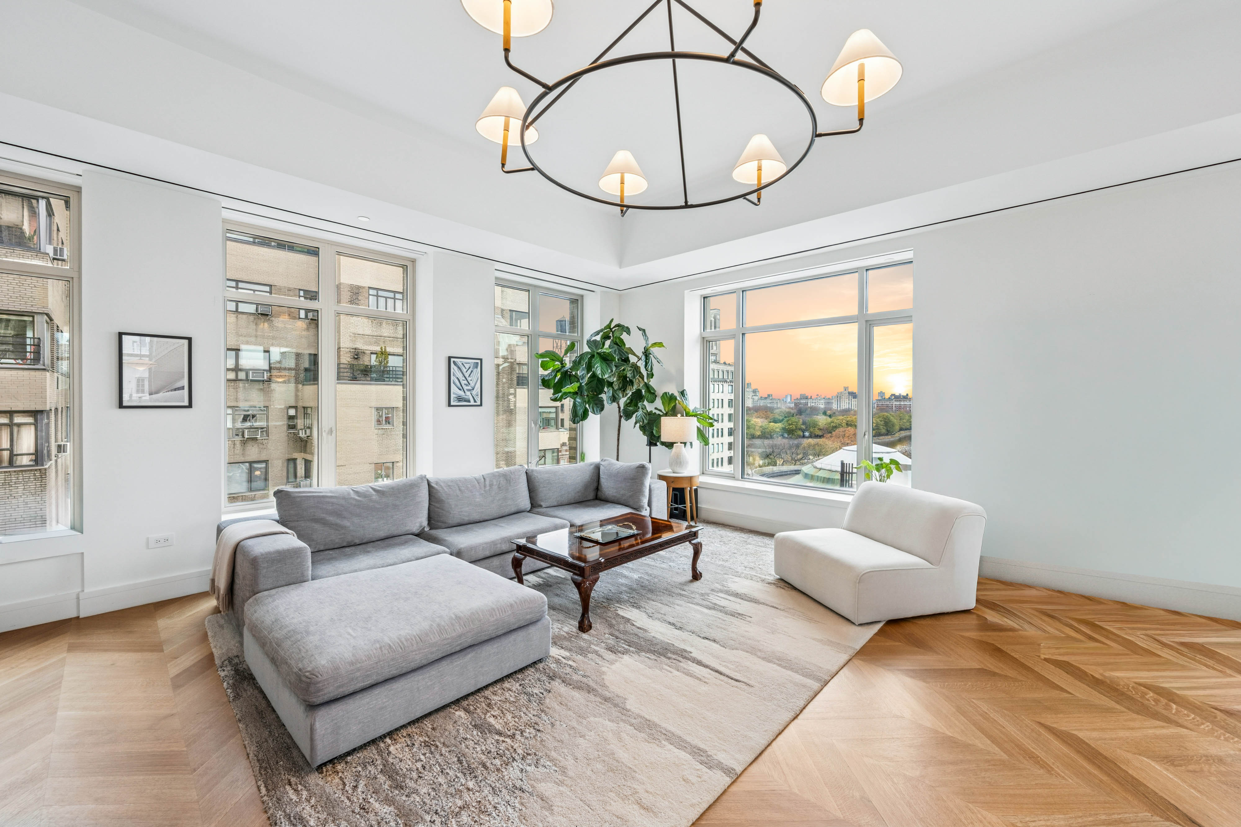 1228 Madison Avenue, Unit 11 Manhattan, NY 10128 - Photo 2 of 22 a living room with furniture a chandelier and a large window