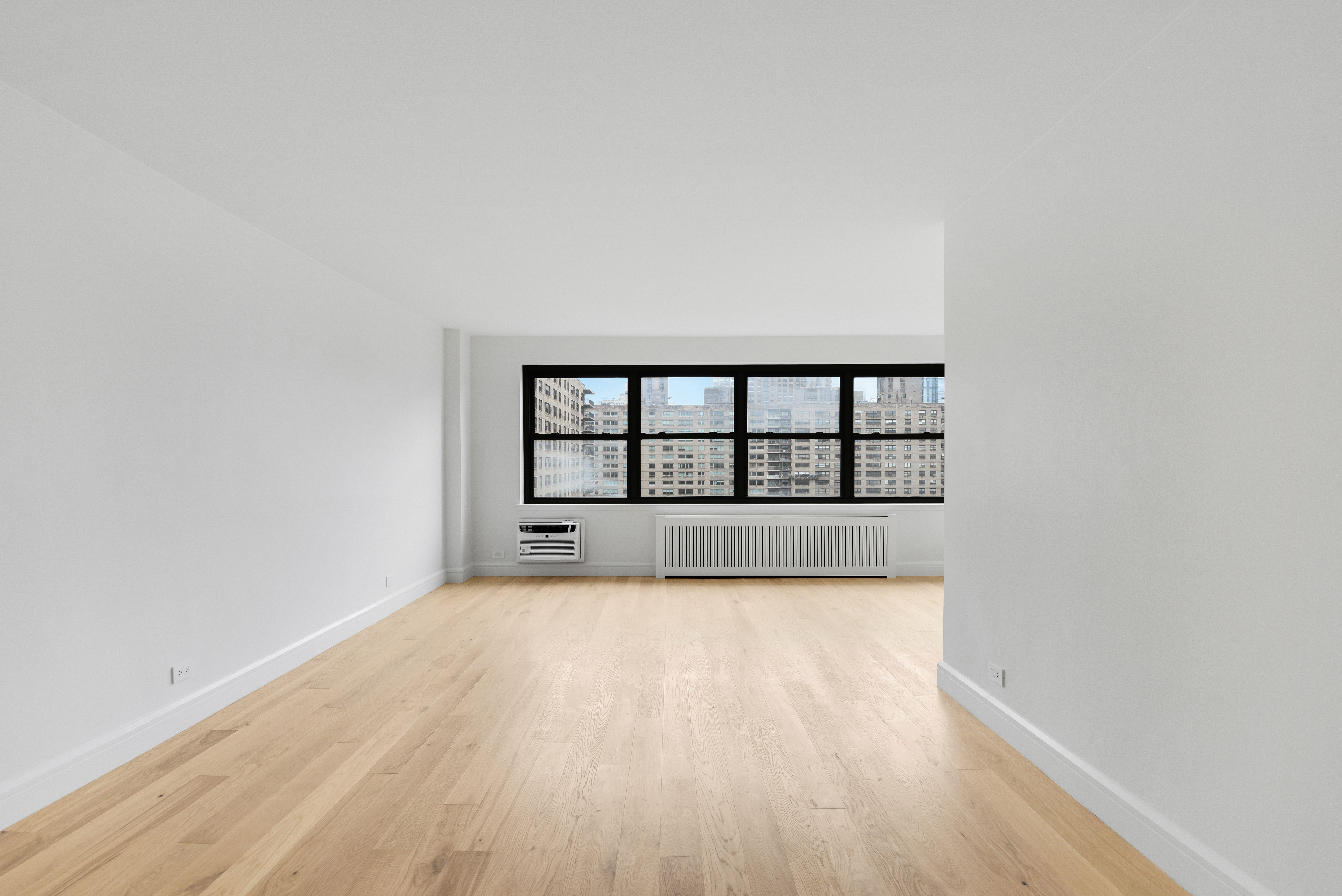 185 West End Avenue, Unit 26J Manhattan, NY 10023 - Photo 4 of 18 a view of a room with wooden floor and a window