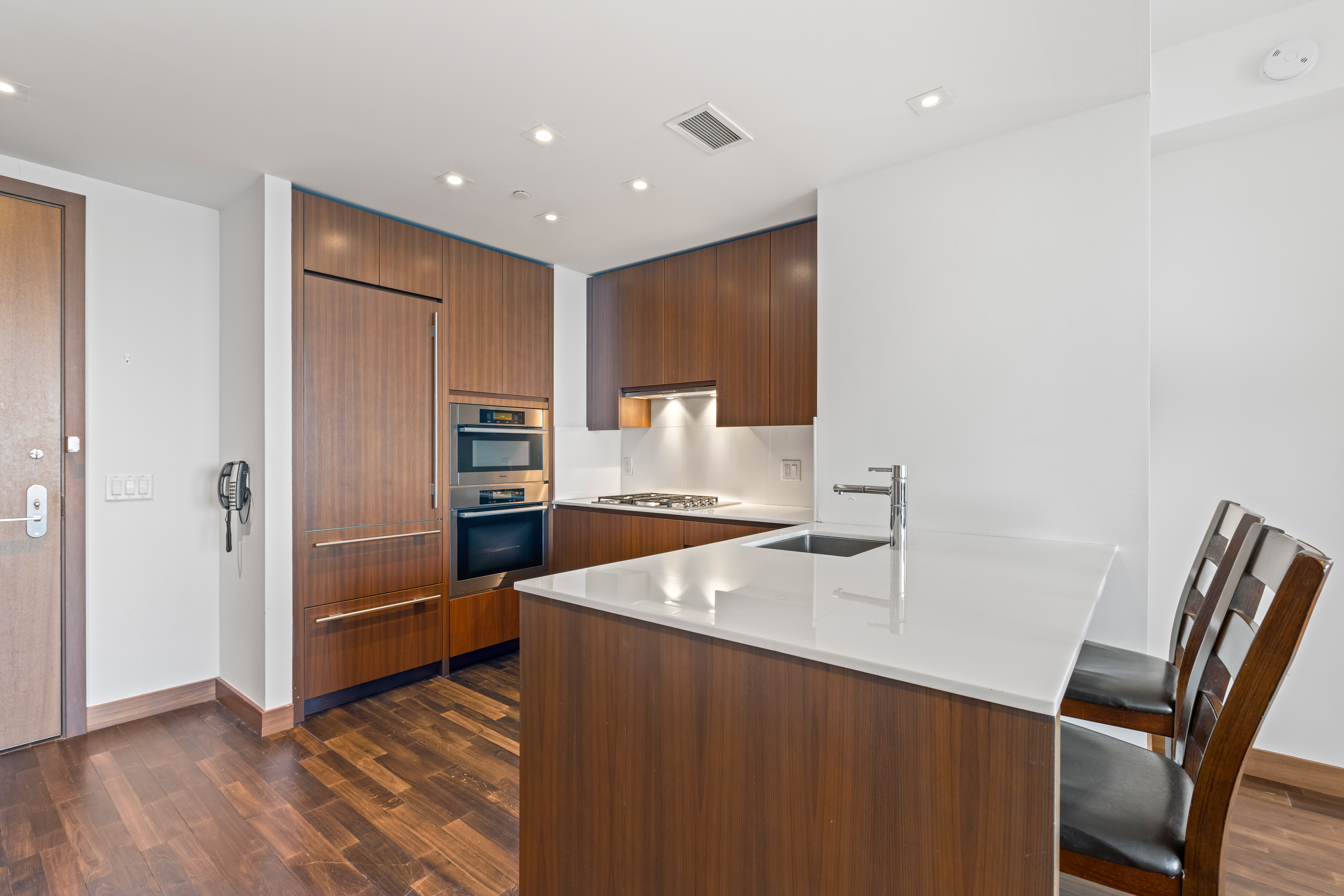 400 5th Avenue, Unit 49C Manhattan, NY 10018 - Photo 5 of 21 a kitchen with stainless steel appliances granite countertop a refrigerator and a sink