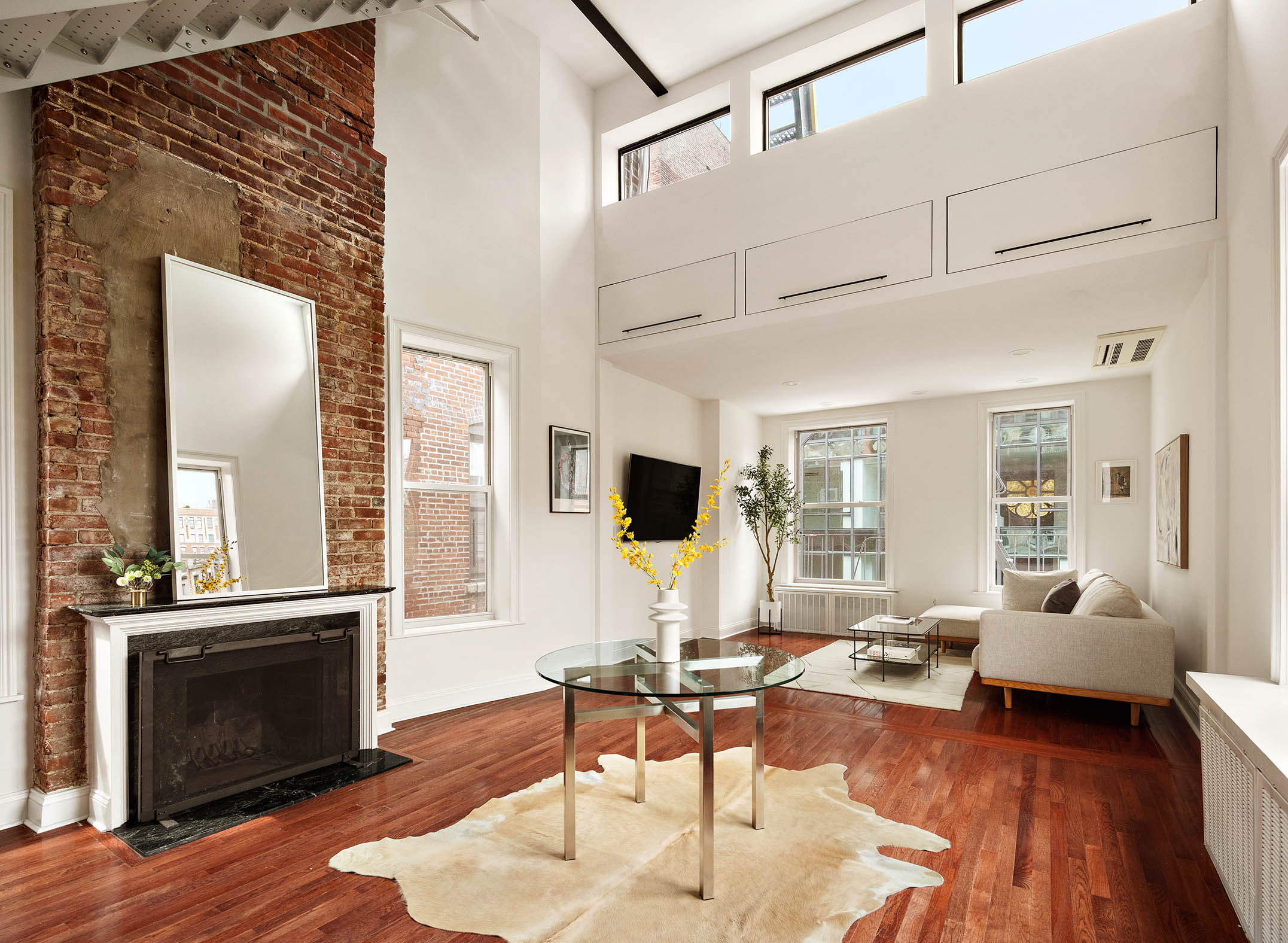 151 West 80th Street, Unit 5R Manhattan, NY 10024 - Photo 2 of 10 a living room with furniture a fireplace and a flat screen tv