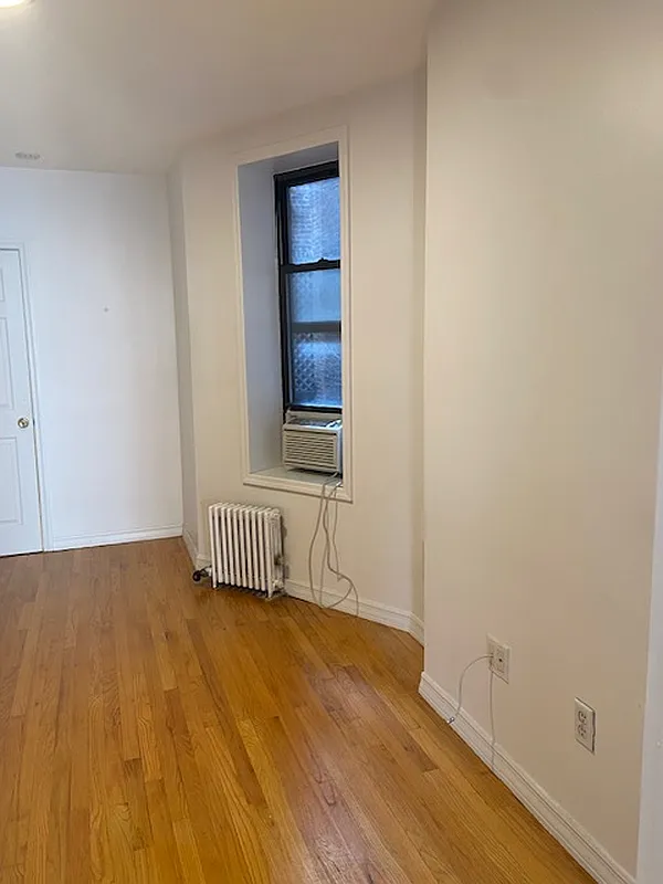178 Ludlow Street, Unit 3A Manhattan, NY 10002 - Photo 3 of 7 a view of an empty room and wooden floor