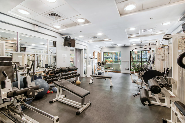 404 East 76th Street, Unit 4M Manhattan, NY 10021 - Photo 9 of 13 a room with gym equipment and wooden floor