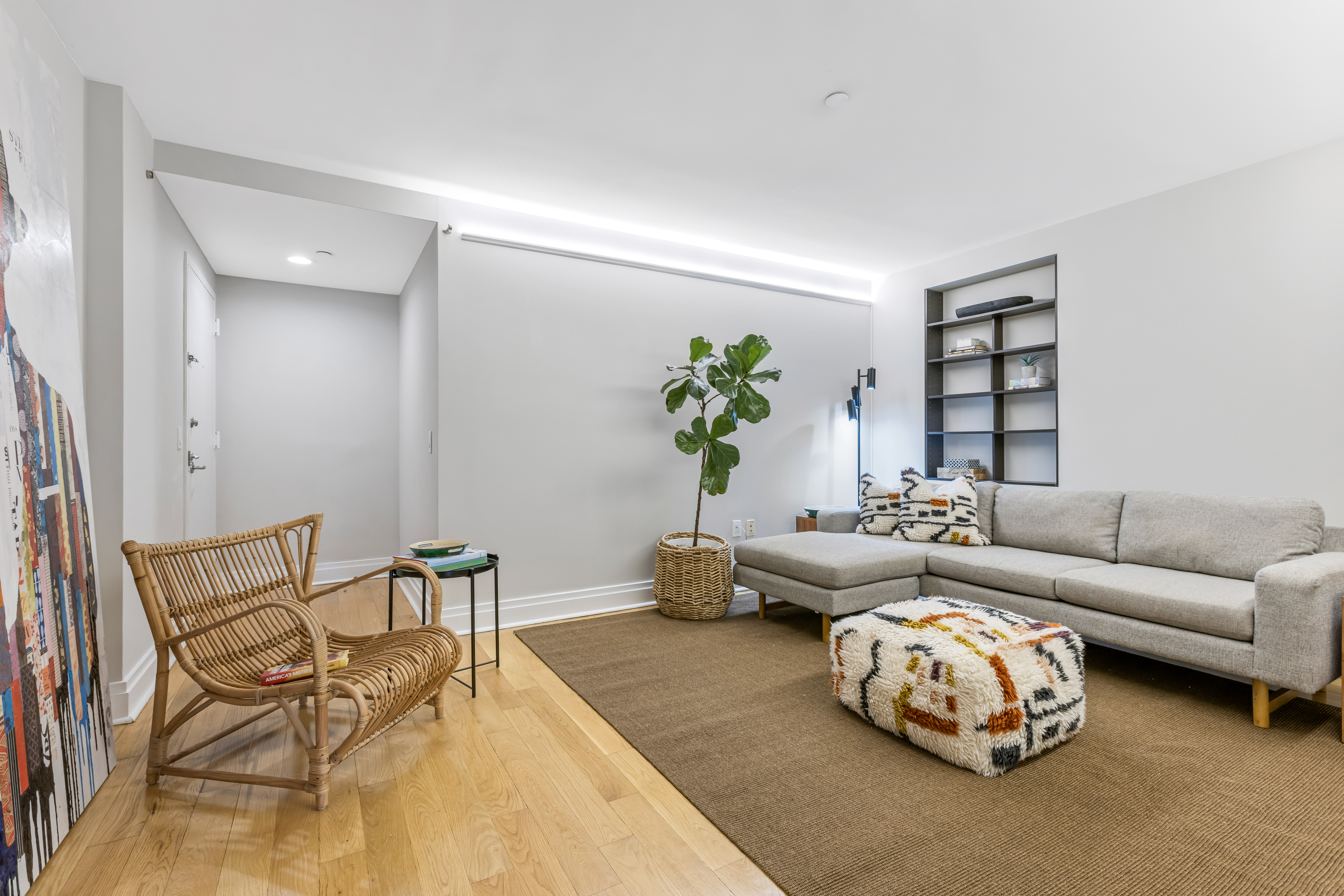 257 West 117th Street, Unit 6A Manhattan, NY 10026 - Photo 11 of 16 a living room with furniture and a potted plant