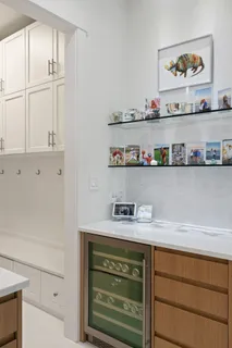a view of cabinets a oven and a refrigerator with white cabinets