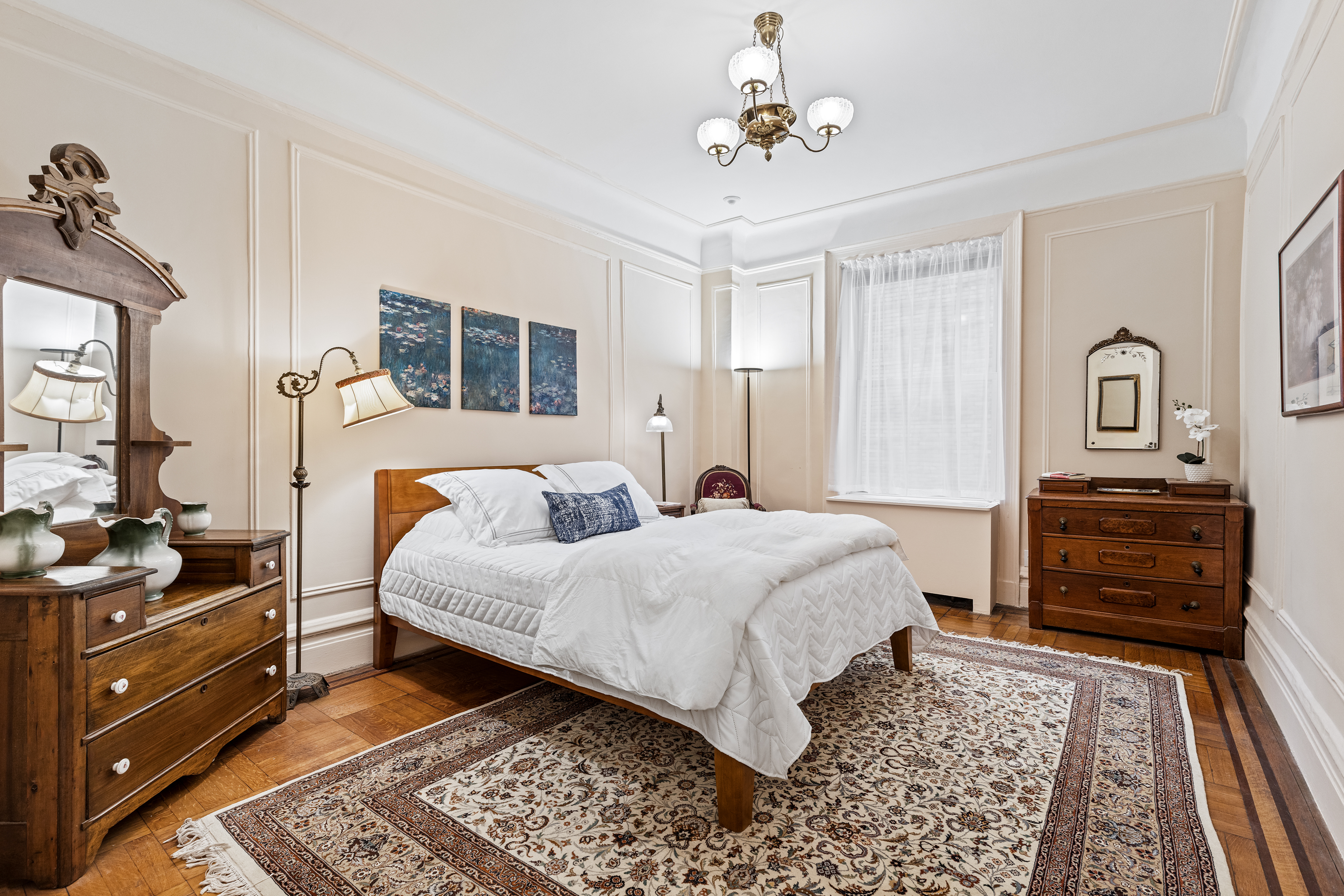 131 Riverside Drive, Unit 2C Manhattan, NY 10024 - Photo 7 of 17 a bedroom with a bed and wooden floor