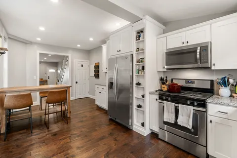 a kitchen with stainless steel appliances a stove a sink and a refrigerator