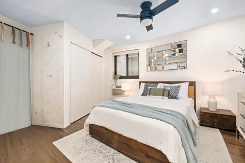 a bedroom with a large bed and a window