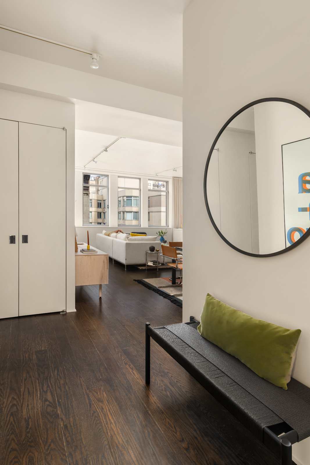 252 7th Avenue, Unit 14G Manhattan, NY 10001 - Photo 11 of 20 a living room with furniture and a wooden floor