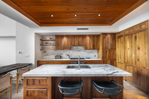 a kitchen with a table and chairs in it