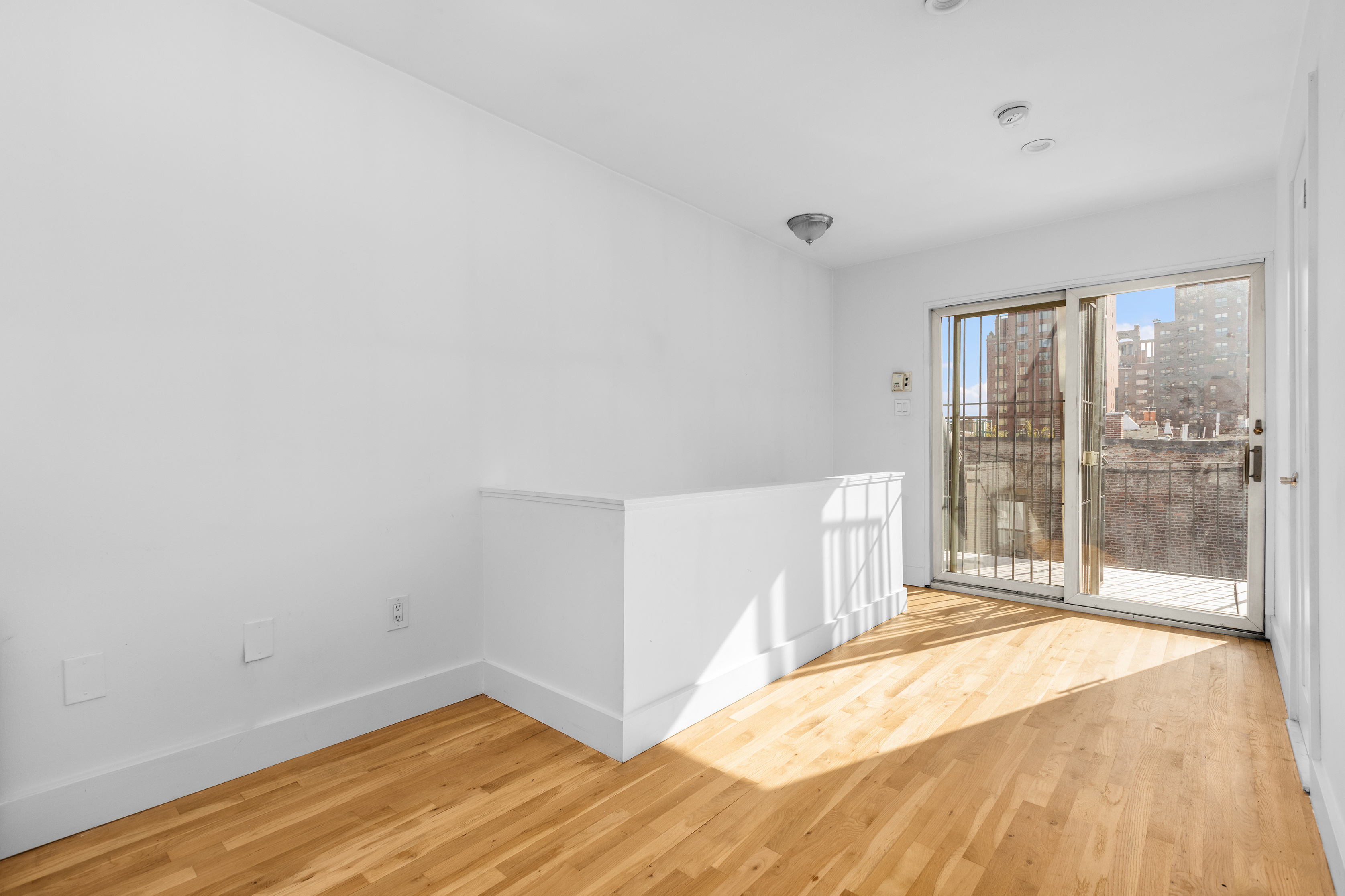 1582 York Avenue, Unit 5B Manhattan, NY 10028 - Photo 3 of 14 a view of an empty room with a window