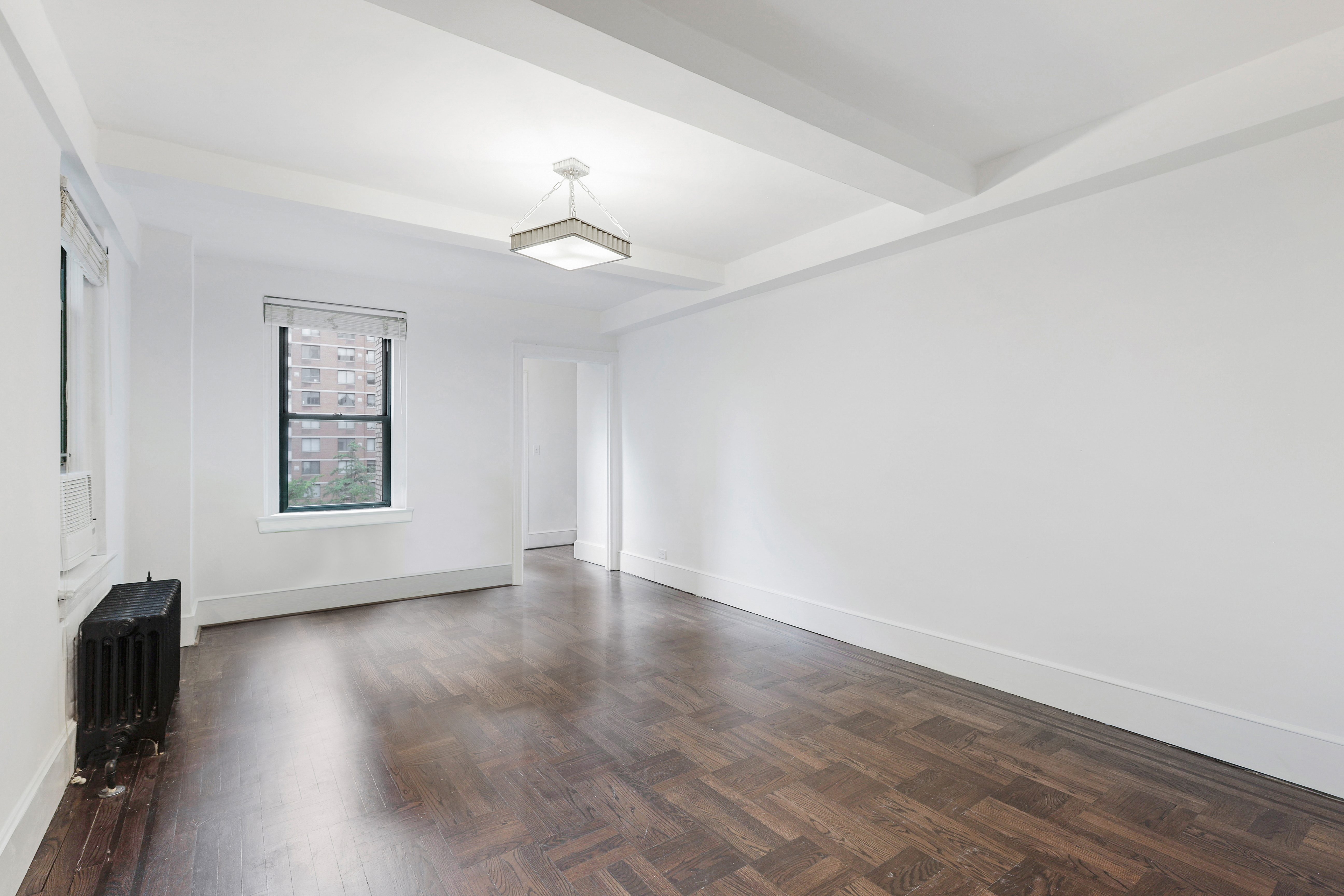 65 West 95th Street, Unit 4D Manhattan, NY 10025 - Photo 7 of 11 wooden floor in an empty room with a window
