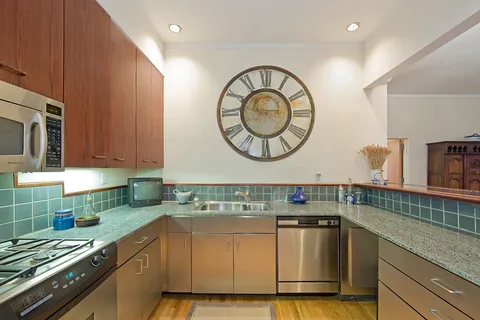 a kitchen with stainless steel appliances granite countertop a sink and cabinets