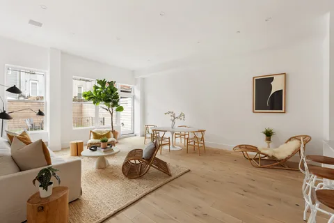 a living room with furniture rug and wooden floor