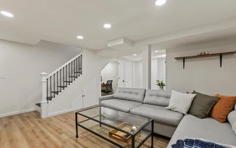 a living room with furniture and wooden floor