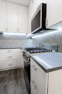 a kitchen with granite countertop a stove and a microwave